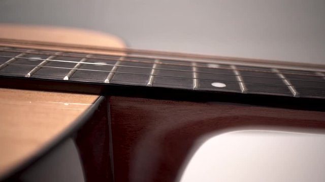 Macro Close Up Slider Shot of Isolated Wooden Acoustic Guitar