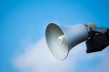 Attention please megaphone on the blue background