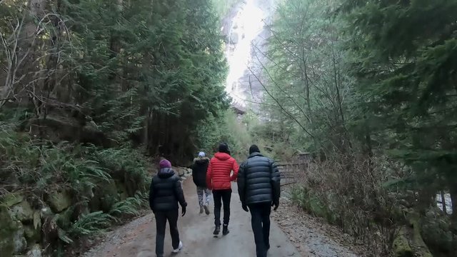 family walking on vacation, below waterfalls near Vancouver, winter time BC