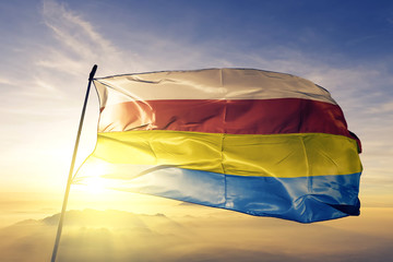 Podlaskie voivodeship of Poland flag waving on the top sunrise mist fog