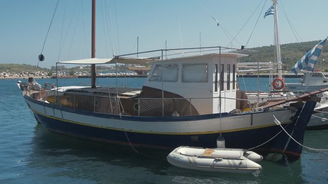Lovely wooden  carvel built sail boat moored at quite Greek village harbor CLOSE UP