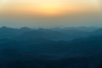 View of the sunrise on the bare mountain from the top of the mountain
