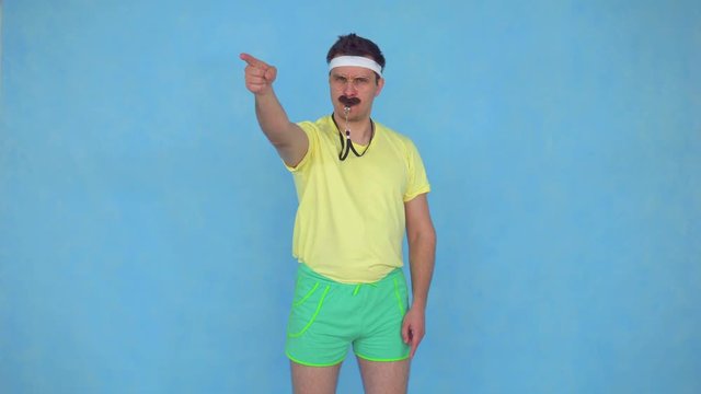 funny male sports coach with mustache whistles in whistle