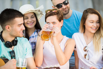 Young and happy group of people with beer outdoors
