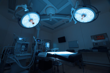 Equipment and medical devices in modern operating room take with art lighting and blue filter