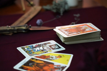 Tarot cards, amulets and ritual knife. Occult, esoteric, divination and wicca concept. Mystic and vintage background.