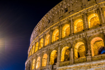 Naklejka premium The Great Roman Colosseum and its arches at night in Rome - Italy