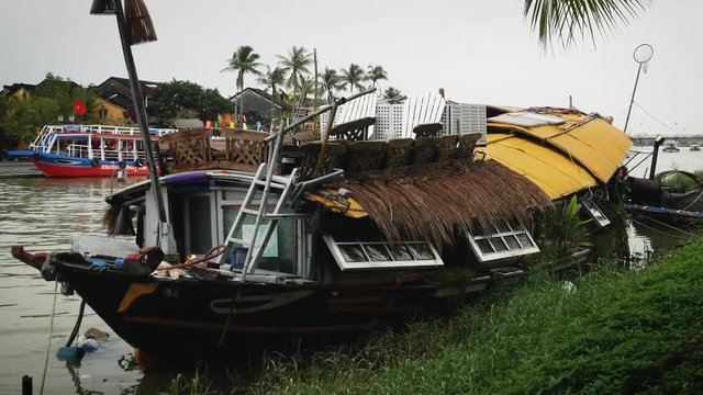 rickety houseboat on the river in Hoi An, Vietnam