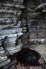 Dinosaur Footprint and sedimentary rocks in famous tourist site Sangjogam County Park in Goseong County, South Korea.