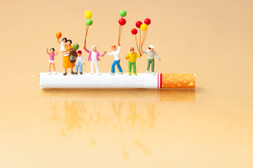 World no tobacco day. Cigarette and family figure. a concept for stop smoking. Smoking a cigarette...