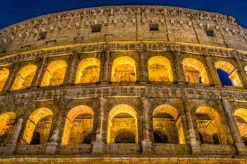 Fototapeta premium The Great Roman Colosseum and its arches at night in Rome - Italy