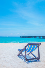Fototapeta na wymiar Beach chairs and bridges with sea and bright sky