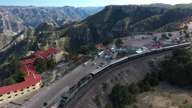 Aerial drone view of the Chepe Train moving at the station of Divisadero in Copper Canyon, Chihuahua, Mexico