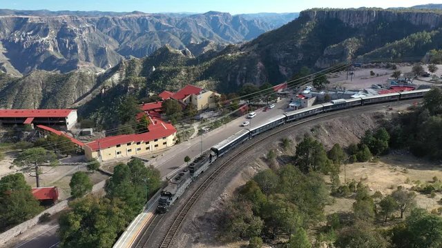 Aerial drone view over the Chepe Train moving at the station of Divisadero in Copper Canyon, Chihuahua, Mexico