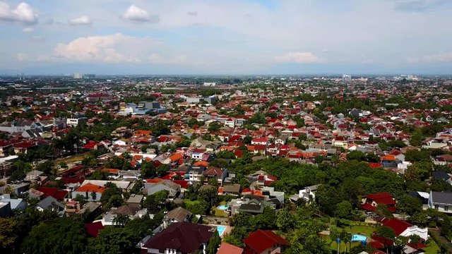 Bird's eye view of a neighborhood in South Jakarta. From above, you can see suburban development in contrast with rice fields in the outskirts of Indonesia's capital.