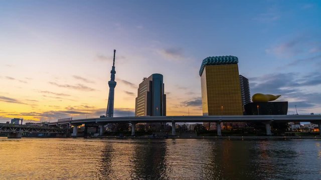 Night to day time lapse of Tokyo skyline on the Sumida River at night, Japan