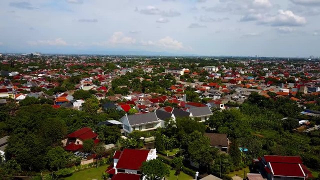 Bird's eye view of a neighborhood in South Jakarta. From above, you can see suburban development in contrast with rice fields in the outskirts of Indonesia's capital.