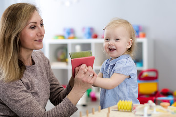 Mother and child playing with developmental toys. Early education concept.