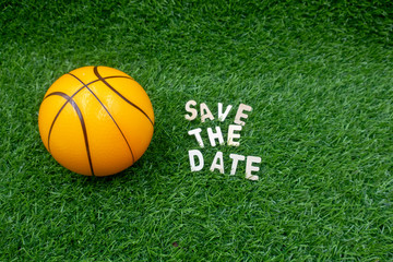 Basketball save the date on green grass.