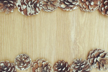 Holiday decoration with Rustic wooden background with pine cones