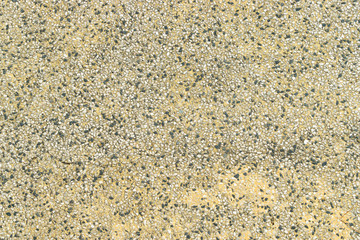 Texture of small black and white stones on pavement