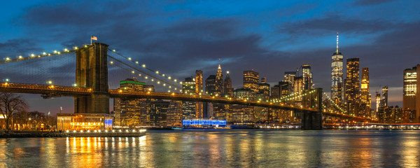 Banner and cover scene of New york Cityscape with Brooklyn Bridge over the east river at the twilight time, USA downtown skyline, Architecture and transportation concept