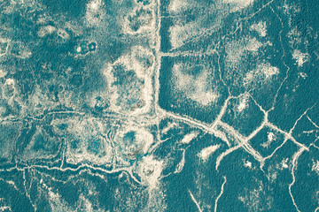 The texture of the concrete wall is blue. Abstract background of blue color with white stains of paint. Original texture for design.