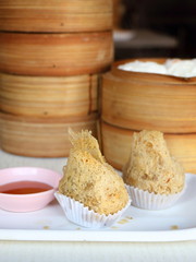 Closeup crispy deep fried taro dumpling in white plate with sweet sauce in dim sum set, Chinese restaurant food style