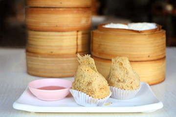 Closeup crispy deep fried taro dumpling in white plate with sweet sauce in dim sum set, Chinese restaurant food style