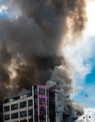 Burning building in thick toxic smoke