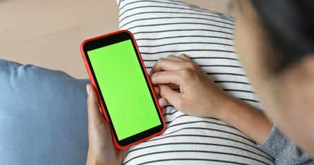 Woman use of mobile phone with green screen