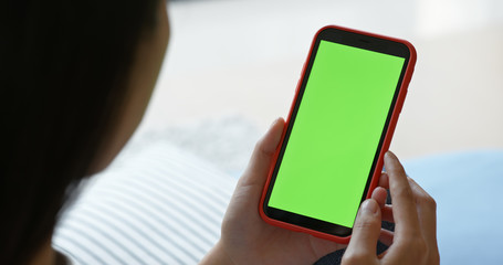 Woman hold with mobile phone with chroma key at home