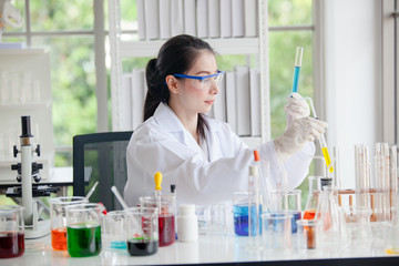 Closeup of a female scientist filling test tubes with pipette in laboratory  science laboratory...