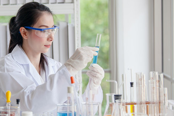 Closeup of a female scientist filling test tubes with pipette in laboratory  science laboratory...