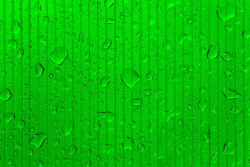 Raindrops on transparent striped juicy green surface