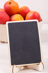 Fresh apricot in wooden box as healthy snack or dessert containing vitamins. Copy space for text on black board