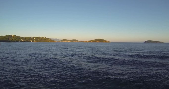 Steady Camera Shoot of Beautiful See and Boats that passing around and tourists on them. Filming in 4k in Skyathos, Greek island. Nice sunset with clear weather and no wind. Touristy and busy place.