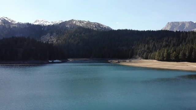 HD Drone shot over a beautiful mountain forest lake