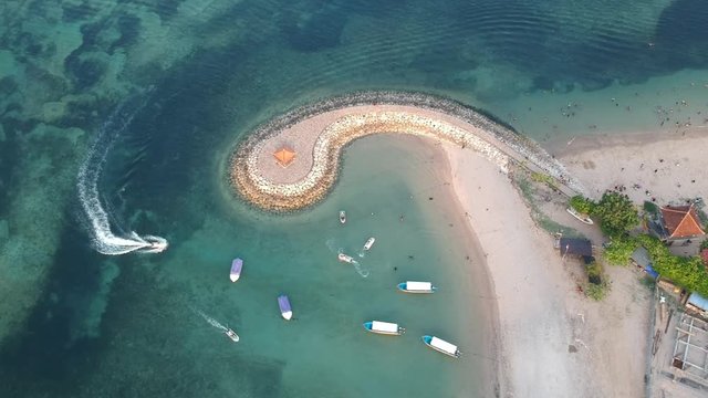Aerial drone view of ocean, boats, beach, shore In Sanur Beach, Bali, Indonesia with with Traditional Balinese Fishing Boats amazing blue ocean.
