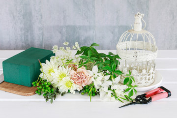 How to make floral arrangement with roses, dahlias and iris flowers inside a vintage bird cage