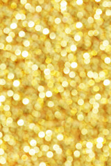 Gold glittering christmas lights. Blurred abstract background.