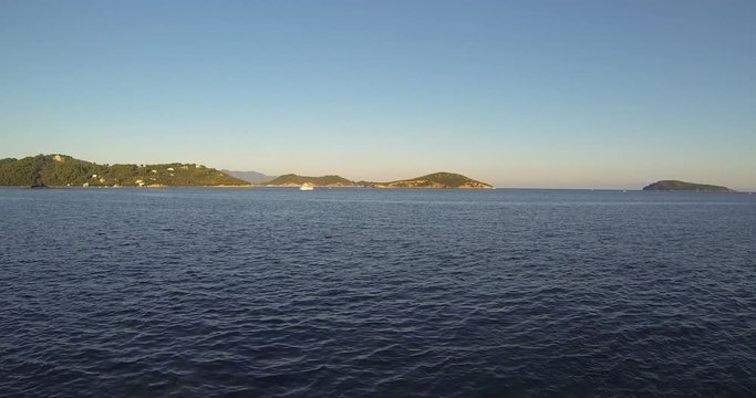 Steady Camera Shoot of Beautiful See and Boats that passing around and tourists on them. Filming in 4k in Skyathos, Greek island. Nice sunset with clear weather and no wind. Touristy and busy place.