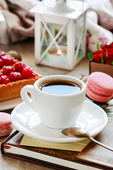 Cup of coffee and sweets around.