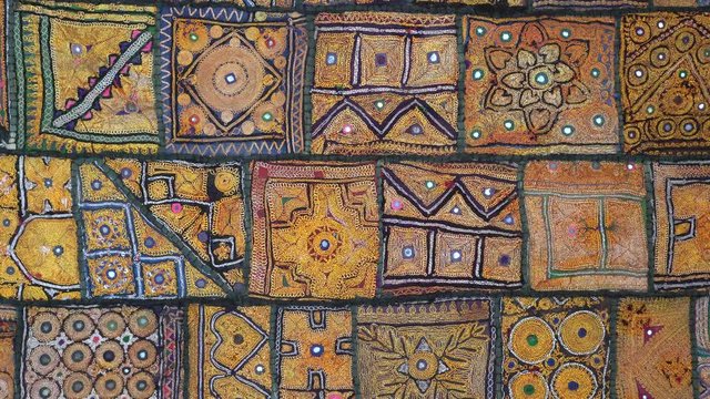 Detail old colorful patchwork carpet, establishing shot. Close up