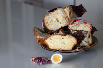 leftover of Easter cake and half a bit of an egg on white table