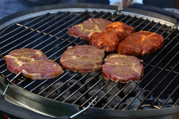 Meat and sausages are fried on the grill