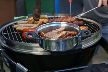 Meat and sausages are fried on the grill