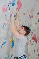 Obraz na płótnie Canvas Sporty man climbing on climbing wall.