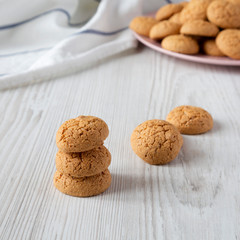 Homemade almond cookies on a white wooden surface, close-up.