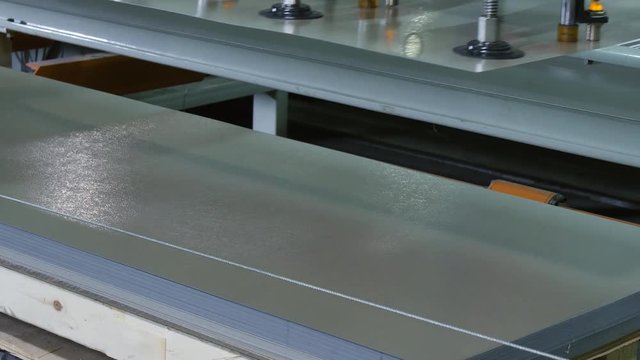 manipulator with suction cups takes metal sheet closeup